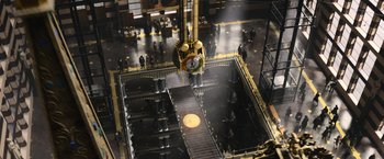 Movie still from “Fantastic Beasts and Where to Find Them” (2016), directed by David Yates – An overhead view of people walking around a building; Extreme Wide shot, Overhead angle