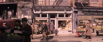 Movie still from “Fantastic Beasts and Where to Find Them” (2016), directed by David Yates – A group of people standing on the side of a street; Wide shot, High angle