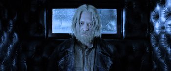 Movie still from “Fantastic Beasts: The Crimes of Grindelwald” (2018), directed by David Yates – A person with a beard and long white hair; Close Up shot, Low angle