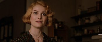 Movie still from “Fantastic Beasts: The Crimes of Grindelwald” (2018), directed by David Yates – A beautiful woman with red curly hair wearing a necklace; Close Up shot, Over the shoulder angle