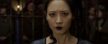 Movie still from “Fantastic Beasts: The Crimes of Grindelwald” (2018), directed by David Yates – A person wearing a dress; Close Up shot, Over the shoulder angle