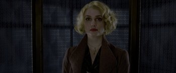 Movie still from “Fantastic Beasts: The Crimes of Grindelwald” (2018), directed by David Yates – A woman with blonde curly hair wearing a brown jacket; Close Up shot, Low angle