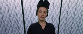 Movie still from “Fantastic Beasts: The Crimes of Grindelwald” (2018), directed by David Yates – A woman wearing a black dress and a black hat; Close Up shot, Low angle