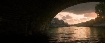 Movie still from “Fantastic Beasts: The Crimes of Grindelwald” (2018), directed by David Yates – A view from under a bridge at sunset; Extreme Wide shot, High angle