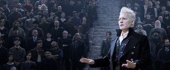 Movie still from “Fantastic Beasts: The Crimes of Grindelwald” (2018), directed by David Yates – A crowd of people standing in front of a staircase; Medium shot, Over the shoulder angle