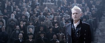 Movie still from “Fantastic Beasts: The Crimes of Grindelwald” (2018), directed by David Yates – A man standing in front of a large group of people; Medium shot, High angle