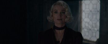 Movie still from “Fantastic Beasts: The Secrets of Dumbledore” (2022), directed by David Yates – A woman with blonde hair wearing a black shirt; Close Up shot, Over the shoulder angle