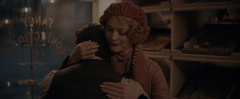 Movie still from “Fantastic Beasts: The Secrets of Dumbledore” (2022), directed by David Yates – A woman is hugging a man in a room; Close Up shot, Over the shoulder angle