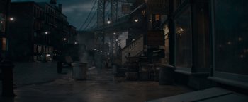 Movie still from “Fantastic Beasts: The Secrets of Dumbledore” (2022), directed by David Yates – A street scene with a bridge in the background; Extreme Wide shot, High angle