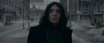 Movie still from “Fantastic Beasts: The Secrets of Dumbledore” (2022), directed by David Yates – A man with long black hair wearing a black jacket; Close Up shot, Low angle