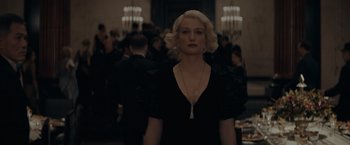 Movie still from “Fantastic Beasts: The Secrets of Dumbledore” (2022), directed by David Yates – A woman with blonde hair wearing a black dress; Close Up shot, Low angle