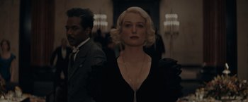Movie still from “Fantastic Beasts: The Secrets of Dumbledore” (2022), directed by David Yates – A woman in a black dress and a man in a black suit; Close Up shot, Low angle