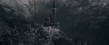 Movie still from “Fantastic Beasts: The Secrets of Dumbledore” (2022), directed by David Yates – A castle on top of a mountain covered in snow; Extreme Wide shot, High angle