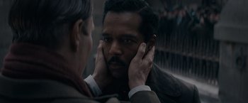 Movie still from “Fantastic Beasts: The Secrets of Dumbledore” (2022), directed by David Yates – A man touching his face with his hands; Close Up shot, Over the shoulder angle