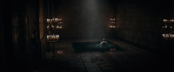 Movie still from “Fantastic Beasts: The Secrets of Dumbledore” (2022), directed by David Yates – A person sitting in a dark room with candles; Extreme Wide shot, High angle