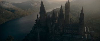 Movie still from “Fantastic Beasts: The Secrets of Dumbledore” (2022), directed by David Yates – An aerial view of a castle in the middle of a lake; Extreme Wide shot, High angle