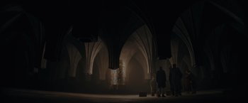 Movie still from “Fantastic Beasts: The Secrets of Dumbledore” (2022), directed by David Yates – A group of people standing inside of a building; Extreme Wide shot, High angle