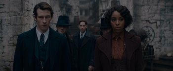 Movie still from “Fantastic Beasts: The Secrets of Dumbledore” (2022), directed by David Yates – A group of men and women standing next to each other; Medium shot, Low angle