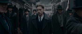 Movie still from “Fantastic Beasts: The Secrets of Dumbledore” (2022), directed by David Yates – A group of men standing next to each other; Medium shot, Low angle