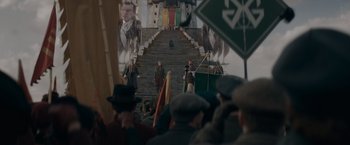 Movie still from “Fantastic Beasts: The Secrets of Dumbledore” (2022), directed by David Yates – A group of people standing on top of a wooden staircase; Extreme Wide shot, Low angle