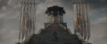 Movie still from “Fantastic Beasts: The Secrets of Dumbledore” (2022), directed by David Yates – A person walking up a set of stairs; Extreme Wide shot, Low angle