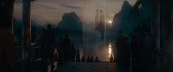 Movie still from “Fantastic Beasts: The Secrets of Dumbledore” (2022), directed by David Yates – A group of people standing on a dock near a body of water; Extreme Wide shot, Low angle