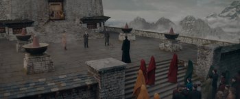 Movie still from “Fantastic Beasts: The Secrets of Dumbledore” (2022), directed by David Yates – A group of people standing on top of a building; Extreme Wide shot, High angle