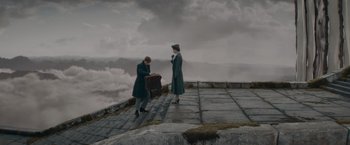 Movie still from “Fantastic Beasts: The Secrets of Dumbledore” (2022), directed by David Yates – A man and a woman standing on top of a hill; Wide shot, Low angle