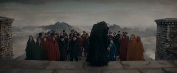 Movie still from “Fantastic Beasts: The Secrets of Dumbledore” (2022), directed by David Yates – A group of people standing in a group; Wide shot, Low angle