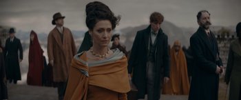 Movie still from “Fantastic Beasts: The Secrets of Dumbledore” (2022), directed by David Yates – A woman in a dress and a man in a suit; Medium shot, Over the shoulder angle