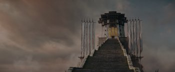 Movie still from “Fantastic Beasts: The Secrets of Dumbledore” (2022), directed by David Yates – A very tall building that has a very long staircase going up it; Extreme Wide shot, Low angle