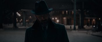 Movie still from “Fantastic Beasts: The Secrets of Dumbledore” (2022), directed by David Yates – A man wearing a hat and a coat; Close Up shot, Low angle