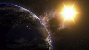 Movie still from “Fantastic Fungi” (2019), directed by Louie Schwartzberg – A view of the earth from outer space with the sun in the background; Extreme Wide shot, Low angle