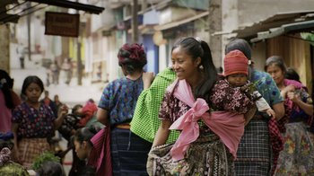 Movie still from “Fantastic Fungi” (2019), directed by Louie Schwartzberg – A group of women walking down a street; Medium shot, Over the shoulder angle