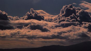 Movie still from “Fantastic Fungi” (2019), directed by Louie Schwartzberg – A view of a cloudy sky at sunset; Extreme Wide shot, Low angle