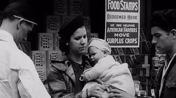 Movie still from “Fantastic Fungi” (2019), directed by Louie Schwartzberg – An old photo of a woman holding a baby; Close Up shot, Low angle