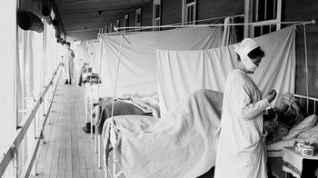 Movie still from “Fantastic Fungi” (2019), directed by Louie Schwartzberg – A black and white photo of a hospital ward; Medium shot, High angle