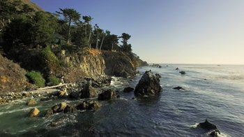 Movie still from “Fantastic Fungi” (2019), directed by Louie Schwartzberg – A view of the ocean from a rocky shore; Extreme Wide shot, High angle