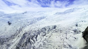 Movie still from “Fantastic Fungi” (2019), directed by Louie Schwartzberg – A view of a snowy landscape from a plane window; Extreme Wide shot, Overhead angle