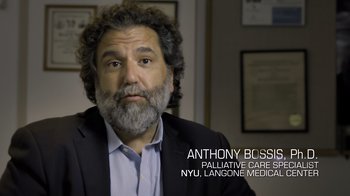 Movie still from “Fantastic Fungi” (2019), directed by Louie Schwartzberg – A person wearing a suit and beard; Medium shot, High angle