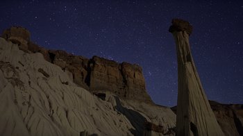 Movie still from “Fantastic Fungi” (2019), directed by Louie Schwartzberg – A night sky with stars and a rock formation in the foreground; Extreme Wide shot, Low angle
