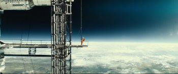 Movie still from “Ad Astra” (2019), directed by James Gray – A man standing on top of a building on top of a tower; Extreme Wide shot, Low angle