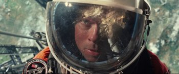 Movie still from “Ad Astra” (2019), directed by James Gray – A man in a space helmet looking into a mirror; Close Up shot, Overhead angle