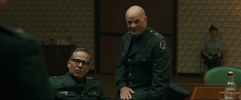 Movie still from “Ad Astra” (2019), directed by James Gray – Two men in uniform sitting next to each other; Medium shot, Over the shoulder angle