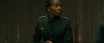 Movie still from “Ad Astra” (2019), directed by James Gray – A woman in a green military uniform looking up; Close Up shot, Low angle