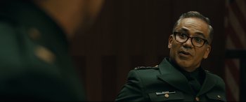 Movie still from “Ad Astra” (2019), directed by James Gray – A man in a military uniform sitting in front of a wall; Close Up shot, Over the shoulder angle