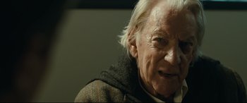 Movie still from “Ad Astra” (2019), directed by James Gray – An older man with white hair and a beard; Close Up shot, Over the shoulder angle