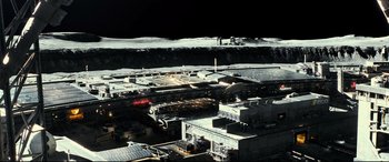 Movie still from “Ad Astra” (2019), directed by James Gray – An aerial view of an airport with a runway and runway lights; Extreme Wide shot, High angle