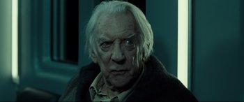 Movie still from “Ad Astra” (2019), directed by James Gray – An old man with white hair stares into the camera; Close Up shot, Over the shoulder angle