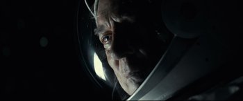 Movie still from “Ad Astra” (2019), directed by James Gray – An older man wearing a space helmet looking at the camera; Close Up shot, Overhead angle